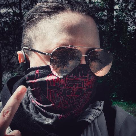 Alt guy selfie, a guy with dark brown hair cut in an undercut, wearing pink mirrored aviators, official arasaka (cyberpunk 2077) tube mask, dark grey with dotted honeycomb pattern and red outline schematic of some kind of robit, and a white hoodie with black hood, stands in front of some kind of nature, trees. Image is dark but clearly sunny.