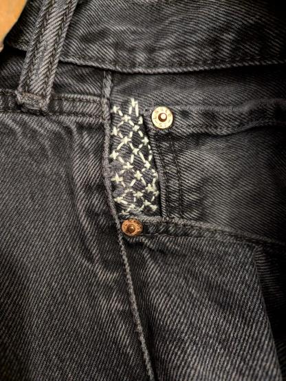 A close-up of some nice sashiko detail next to a jeans pocket.