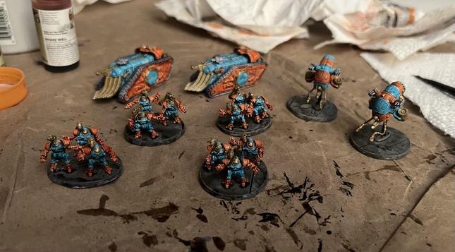 Legion Imperialis Mechanicum miniatures. 

All using speed paints, Caribbean Ocean and Nuclear Sunrise with Hoplite Gold accents. 

2 Triaros Transports
2 Vultarax Hovering Assailt Squid Things
4 squads of Castalax Robots
