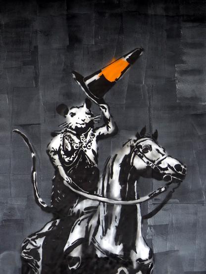Street art: the Duke of Wellington, a rat, raises his traffic cone in salute.