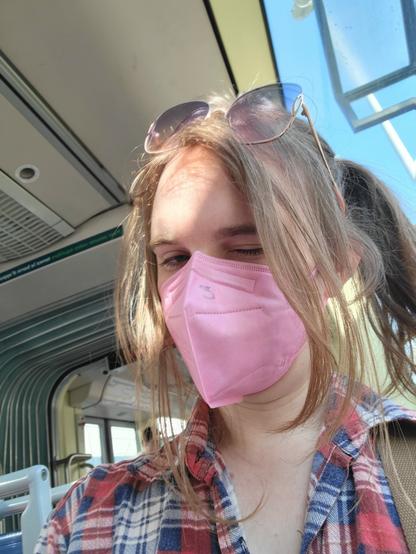 white flanel tgirl w pink FFP2 mask and her initial letter of name (E) written on the mask