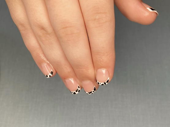 Little hands with a French tip in white/black cow print