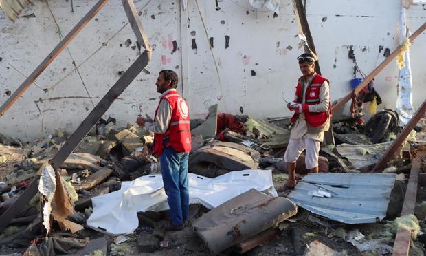 Personal de la Media Luna Roja, en shock, tras acceder a las ruinas del centro de detención de migrantes objeto de un bombardeo de EEUU, en Saada (Yemen). (REUTERS/Naif Rahma)