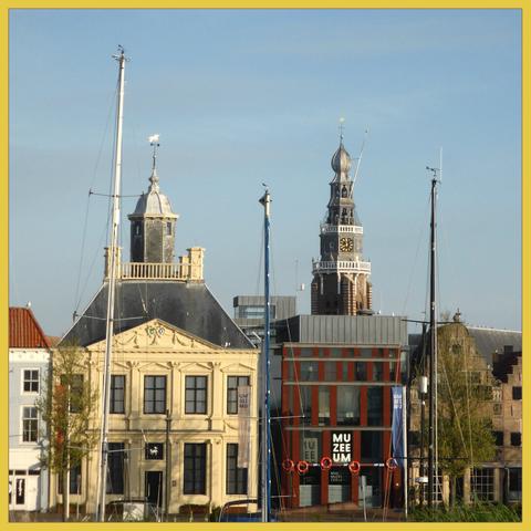 Facade of museum of Vlissingen (spelled MuZEEum)
In front you see boatmasts, in the background the tower of the St. Jacobs church.
