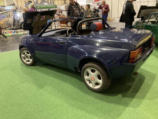 Blue Midas Gold convertible, side view