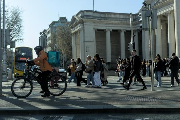 People crossing the road at traffic lights in dublin city centre