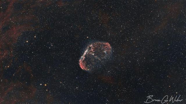 Subject: Crescent Nebula (NGC 6888). This version is processed in HOO, meaning H-alpha (naturally red) is mapped to the red channel and Oxygen-3 (naturally blue) is mapped to the blue and green channels. This is a more natural look than the other SHO image.