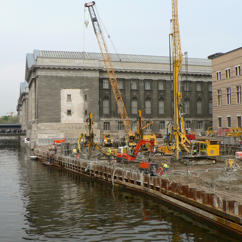 construction cranes beside the Spree and the Neues Museum