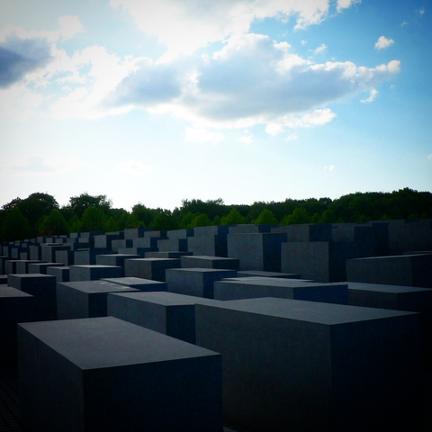 the somber stele of the Denkmal für die ermordeten Juden Europas against an evening blue sky