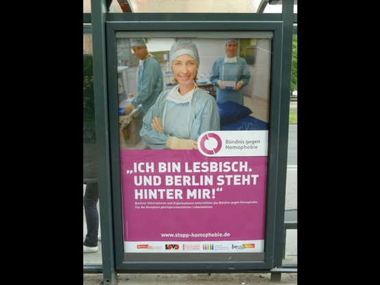 bus shelter poster with photo of woman and quotation, "Ich bin lesbisch, und Berlin steht hinter mir!"