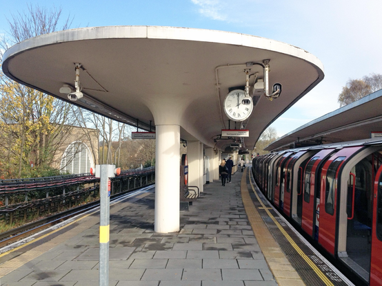 A colour photograph of the curving platform shelters at Loughton underground station