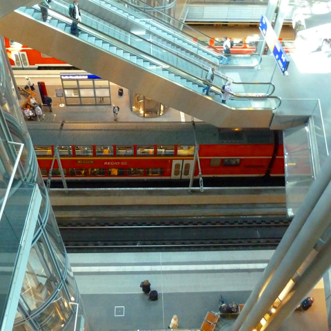 interior of Berlin Hauptbahnhof, looking down several levels to see trains