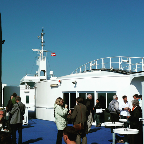 the top deck of the ferry, with train passengers enjoying the open air and sun
