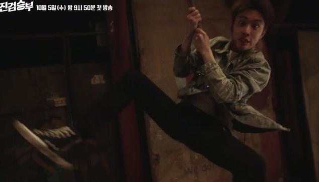 Doh Kyungsoo in his role as Jin Jeong from the kdrama Bad Prosecutor. He swings in on a chain, legs akimbo, holding on for dear life, face hilariously terrified.