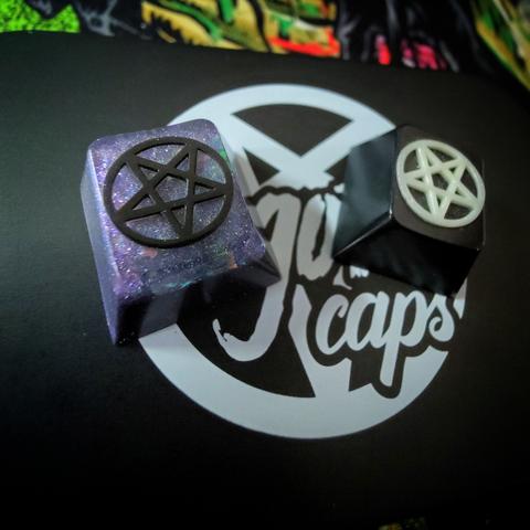 photograph of two artisan keycaps from GothCaps