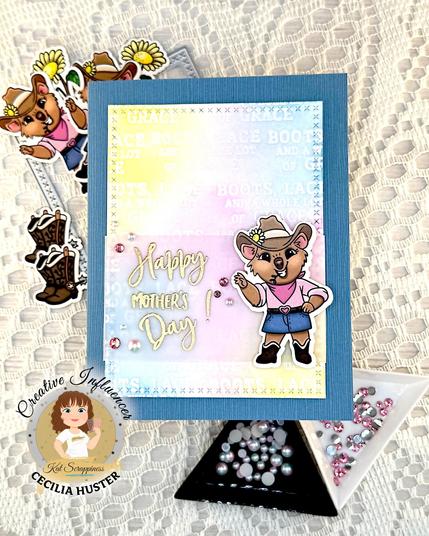 A blue greeting card featuring a cartoon quokka dressed as a cowgirl. The greeting reads "Happy Mother's Day!"