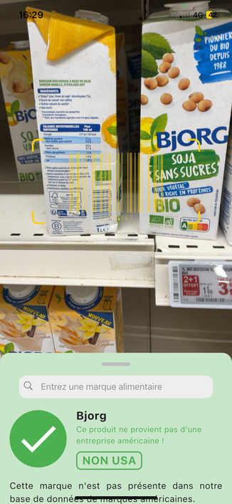 This screenshot of the mobile app shows an image of a soy drink from the supermarket and, below, there is a green information box that says the product isn't from the USA.