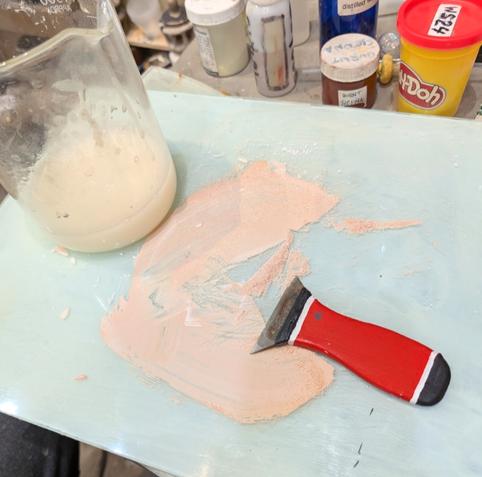 Mixing casein and kaolin on a glass plate