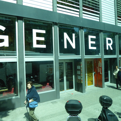 Exterior of the Generator Hostel Barcelona, seen through a shuttle bus window.