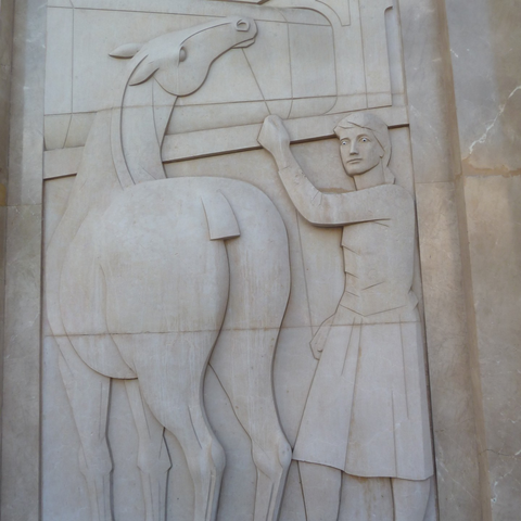 Bas-relief sculpture of a horse and worker, on the face of a building at the corner of Passeig de Gràcia and Gran Via de les Corts Catalanes, Barcelona