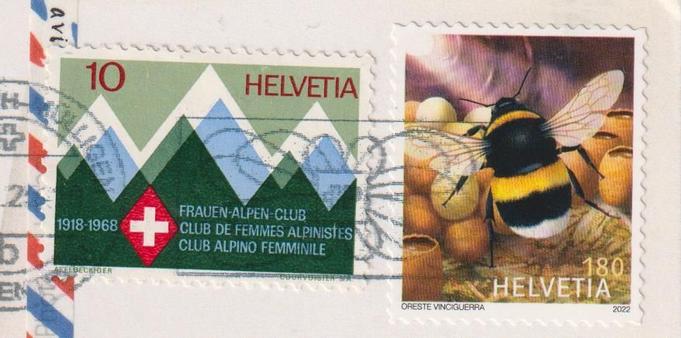 Stamps of a postcard from switzerland.
One 10 Helvetia stamp with mountain silouhetes on it.
There is the following written on it:
1918-1968 Frauen-Alpen-Club / Club de Femmes Alpinistes / Club Alpino Femminile (Woman Alps Club).

The other stamp is a 180 Helvetia Stamp with a bee on it.