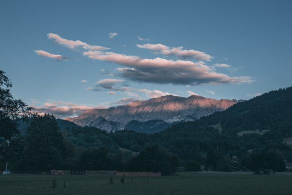 Blue hour in Garmisch with the sun painting the mountain in the Wettersteingebirge orange.