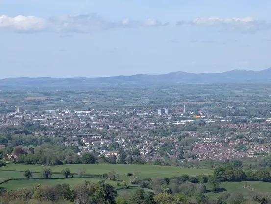 A picture of Gloucester from above. You can see various landmarks across the city, such as the Cathedral, The Forum, Kingsholm Stadium, Gloucestershire Royal Hospital and a storage place...

Hills can be seen in the background, likely Malvern Hills