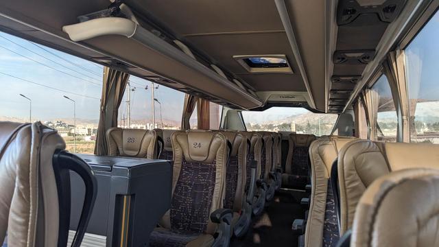 Interior of a mainline bus with comfortable leather seats.