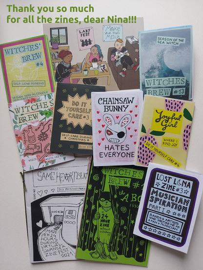 a postcard and a lot of colourful minizines