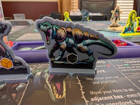 Close-up table level picture of Uprising: Curse of the Last Emperor focused on the T-Rex acrylic standee unit for the traitor legion faction.