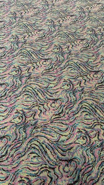 Carpet pattern fills the whole photo. It is a swirling pattern somewhat like marbling, done in a four-color separation with black and three punchy neons.