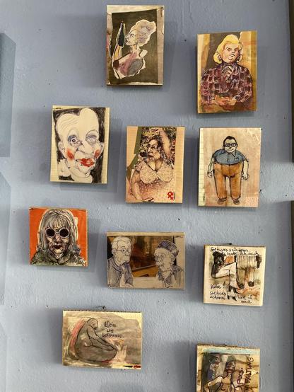 small pictures on a grey wall with small, caricature-like paintings of old people