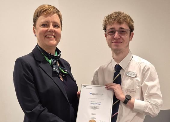 Harry Gutteridge receiving his apprenticeship certificate