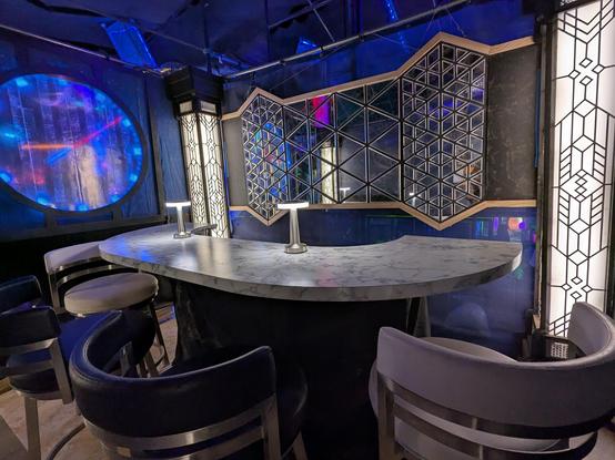 A 4-seat bar with art deco styling including a circular window displaying an LED clock.