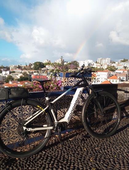 ebike standing with rainbow on the horizon