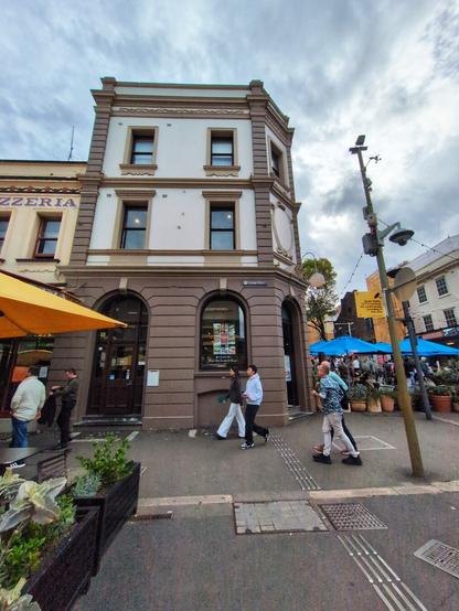 A charming mocha and brown building sits on the corner.