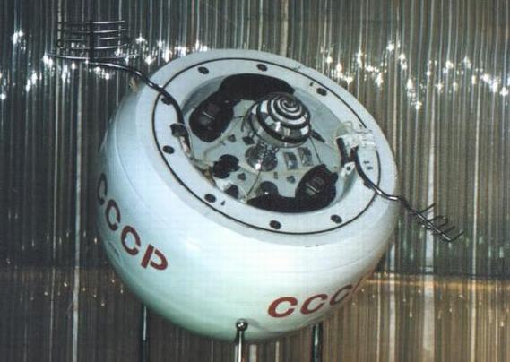 This is an image of a museum replica of the Venera 8 descent craft that is in a decaying orbit around the Earth. The decent craft is basically a one meter diameter sphere that was designed to land on the planet Venus back in the early 1970's. The craft is painted white and has large red letters painted around its circumference denoting its country of origin 'CCCP' (Soviet Union). One face of the sphere contains a small silver dome that was used to connect the lander to its launch vehicle. Spread out on either side of the small silver dome are a pair of dark colored radio antennas that the craft would use to communicate with the team of engineers on Earth, I believe that these also acted as radiators to cool the craft in the high temperatures that it would encounter on the surface of Venus. The craft contained a suite of instruments to measure the atmosphere of Venus during its decent to the surface.

Image credit: NASA