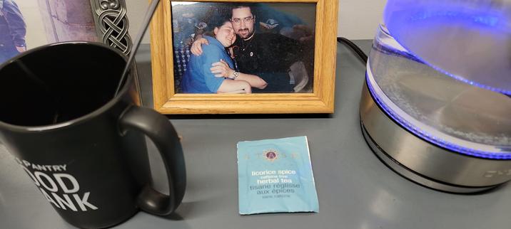 Licorice Spice Tea packet.
Surrounded by:
God's Pantry Food Bank mug.
Photo of Arianna & I from 1999.
Clear glass kettle.