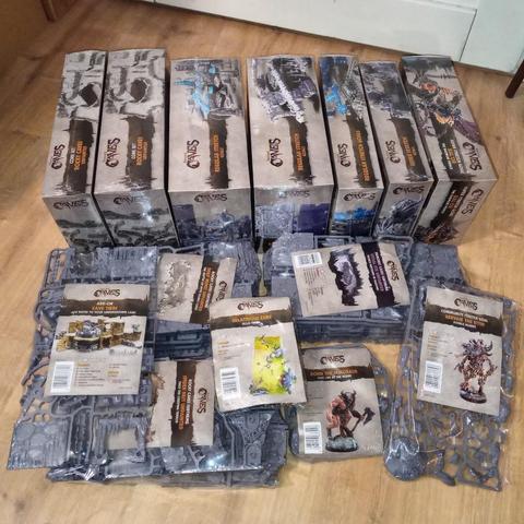 Seven large boxes of "Dungeons and Lasers: Caves" model kits, and a similar number of kits which are just sprues in shrinkwrap, all on my floor.