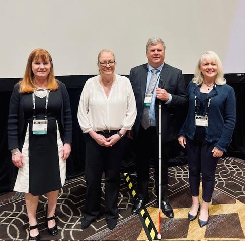 From left to right, Goldstein &amp; Levy's Eve Hill, McGlinchey Stafford's Susan Fahey Desmond, Vispero's Matt Ater, and  Troutman Pepper Locke's Lori Sommerfield standing in a row and smiling.