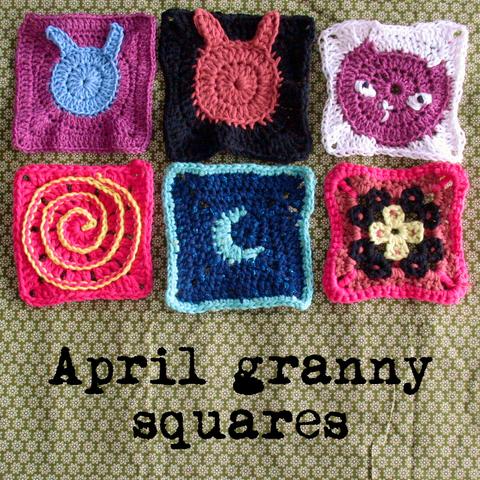 6 granny squares with different designs and colours on a green flower pattern fabric. The designs include bunnies, a cat, a spiral, and a moon. Text below: April granny squares.