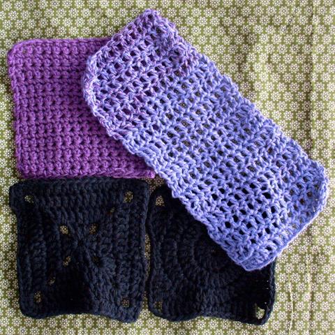 3 different granny squares in purple and black and a longer lilac crochet strip on a green flower pattern fabric.