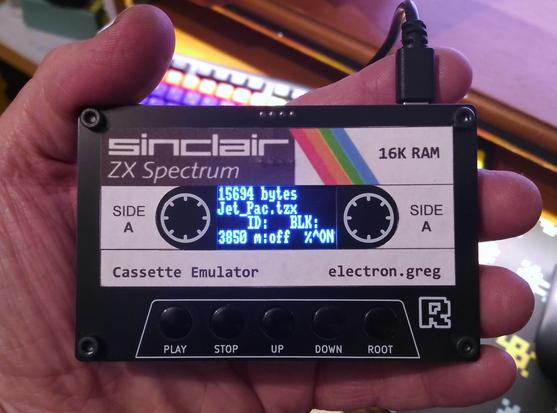 My Maxduino tape emulator that has a homemade cassette label stuck on. It is in the style of early Sinclair Research software releases. The device itself looks almost identical to an audio cassette but with buttons, sockets for USB power cable and audio cables. It also has an LED matric display where the cassette window would normally live.