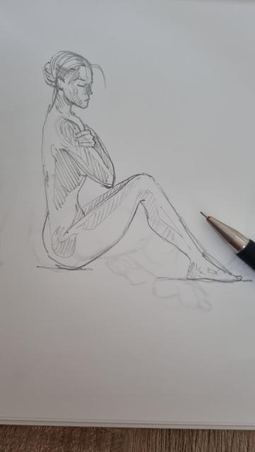A sketch of female model sitting in profile, arms crossed over chest.