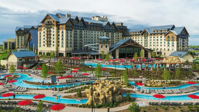 Exterior photo of the Gaylord Rockies Resort and Convention Center showing the waterpark in the foreground, and the multi-winged hotel in the background