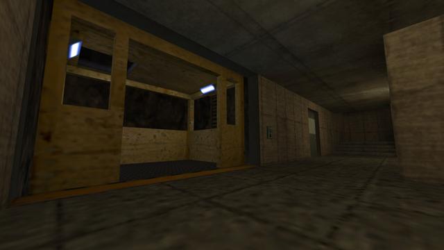 In this picture you can see a yellow freight elevator. This has two white-lit lamps on the left and right of the ceiling. Furthermore, it has a square hole in the ceiling. To the right of the elevator is a button to call the elevator. A little further to the right is a metal door and to the right is a staircase. This is on the map cs_siege in the game Counter-Strike 1.6.