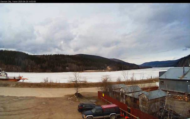 Webcam image from the Dawson Fire Station looking west-northwest across the Yukon River at 353pm MDT.