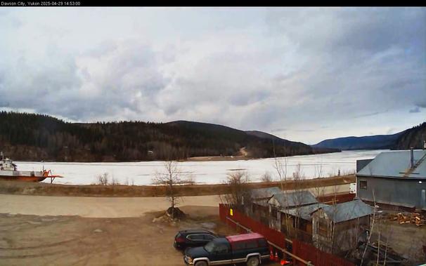 Webcam image from the Dawson Fire Station looking west-northwest across the Yukon River at 353pm MDT.