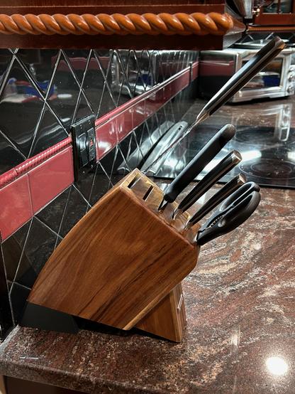 The printed wedge is under the knife block, angling it foward so the knives clear the cupboard.  The top knife is pulled most of the way out to demonstrate.