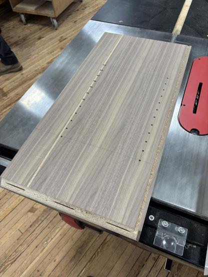 I fixed an oopsie- an errant set of shelf pin holes got drilled wrong, so this is the fix- cut out a full section of the veneer and then replace it.